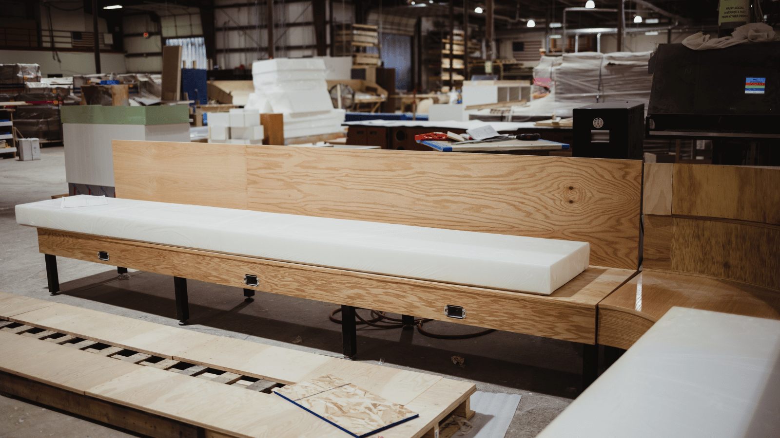 Internal view of Randal Retail Group factory with white plank on brown wood table.